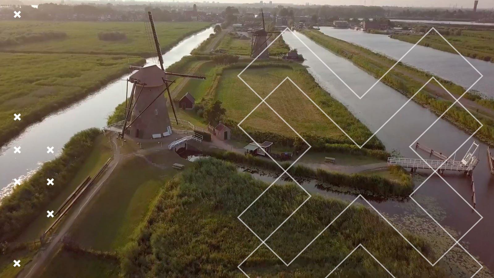 Landscape of a windmill watermarked with the double x Mills Nutrients Home logo